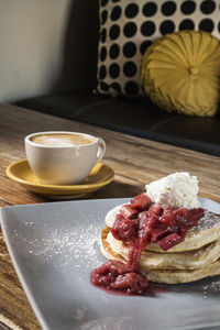 Close-up of coffee and pastries on table