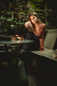 Young woman sitting on floor