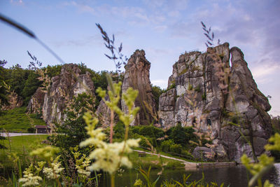 Low angle view of rocks on mountain against sky