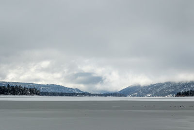 Scenic view of frozen lake against sky