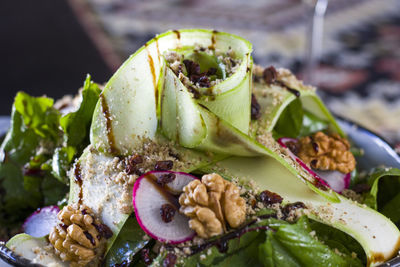 Salad with walnuts, greens and vegetables, close-up