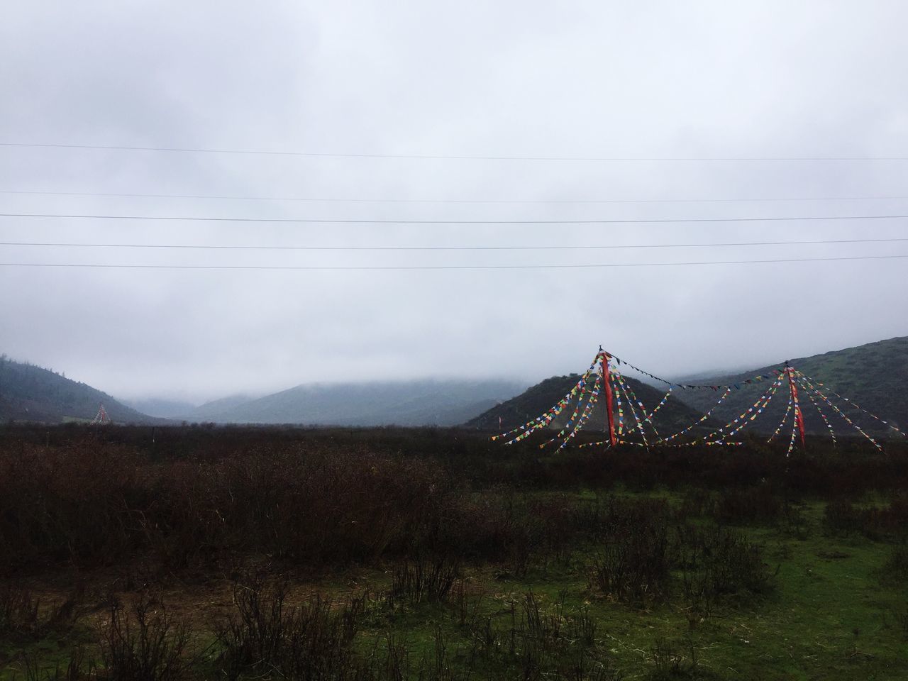 connection, sky, cable, cloud - sky, suspension bridge, mountain, bridge - man made structure, no people, outdoors, travel destinations, nature, landscape, day, built structure, transportation, architecture, bridge, scenics, electricity, beauty in nature