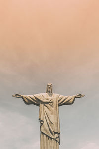 Low angle view of cross statue against sky