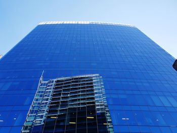 Low angle view of modern building against clear blue sky