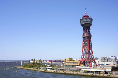 View of tower in city against clear sky