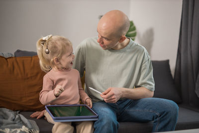 Side view of boy using digital tablet at home