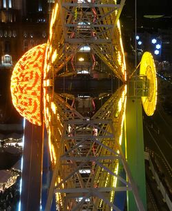 Illuminated bridge in city at night