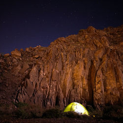 Scenic view of rock formation against sky at night