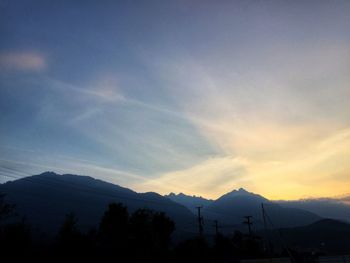 Scenic view of silhouette mountains against sky at sunset