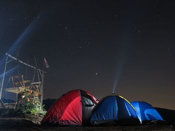 Illuminated tent against sky at night