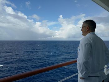 Man standing by sea against sky