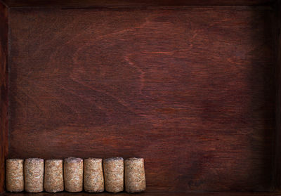 Close-up of corks in wooden drawer