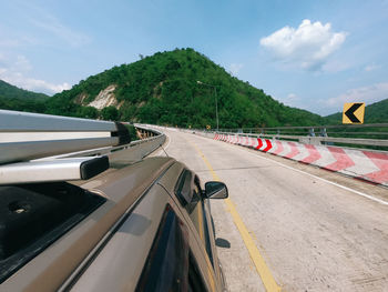 Cars on road against sky