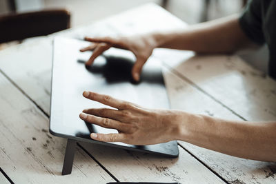 Businessman using graphics tablet on cafe table