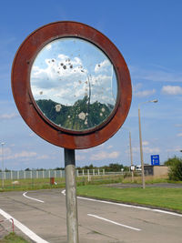 Road sign against sky