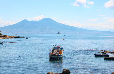 Boat sailing in sea against sky