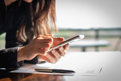 Midsection of man using mobile phone