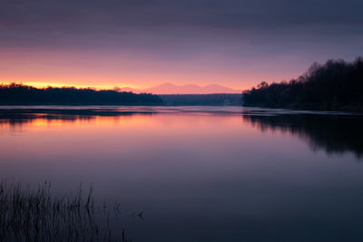 Scenic view of river against sky during sunset