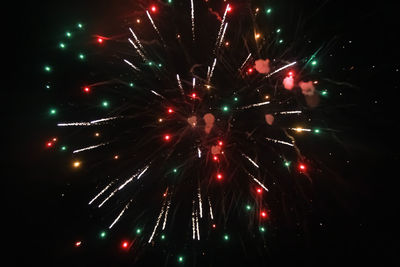 Low angle view of firework display at night