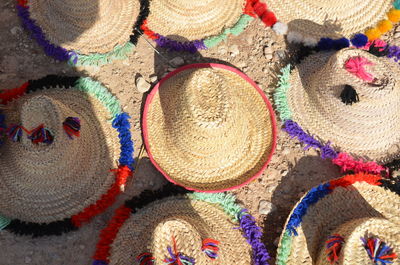 High angle view of hats on field for sale at market