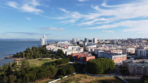 High angle view of buildings and trees against sky