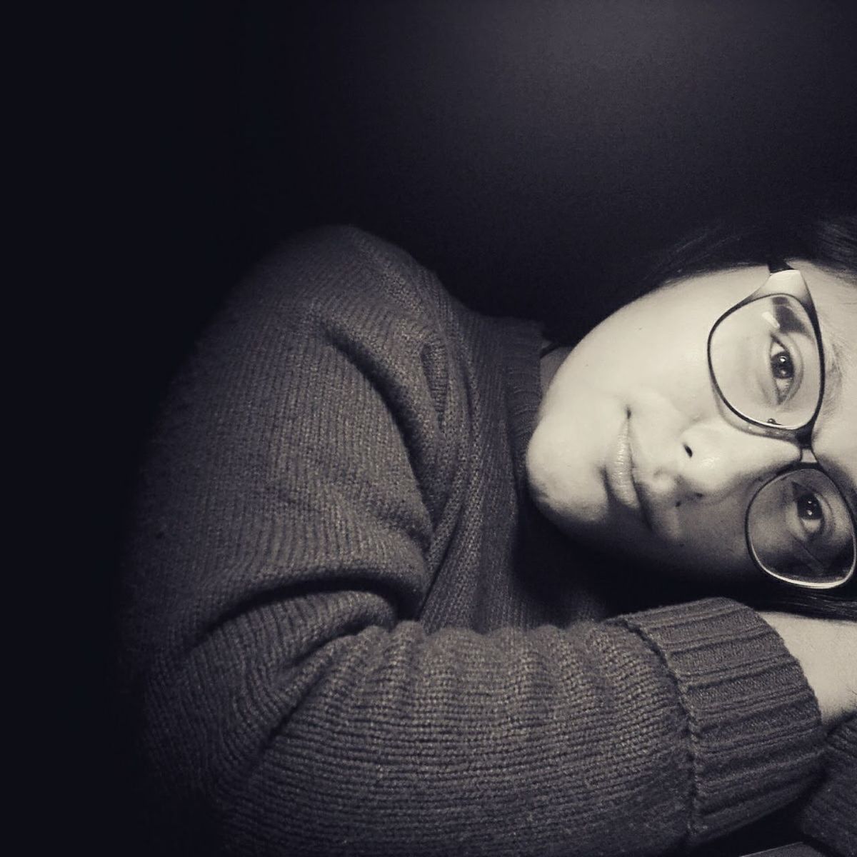 black, darkness, black and white, white, one person, monochrome photography, monochrome, close-up, indoors, portrait, glasses, hand, portrait photography, adult, person, relaxation, lifestyles, lying down, young adult, looking at camera, human face, light, arm, headshot, finger, copy space, human eye, photo shoot