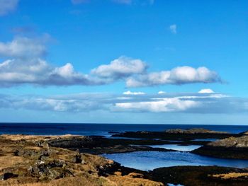 Scenic view of sea against blue sky