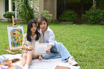 Young couple sitting outdoors