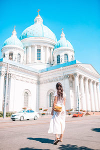 Full length of woman outside temple against building in city