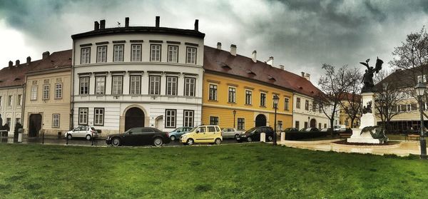 View of buildings against cloudy sky