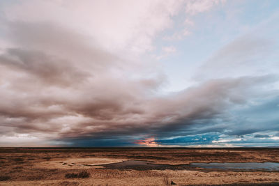 Scenic view of desert against sky during sunset