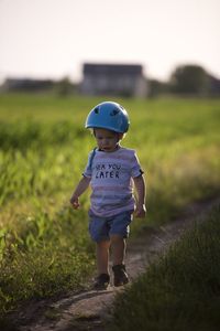 Portrait of boy standing on field