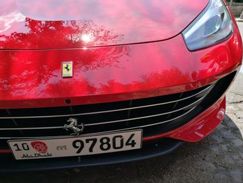 Close-up of red car against sky