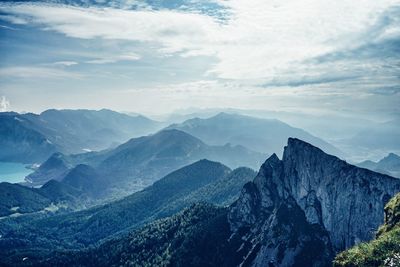 Scenic view of mountains against cloudy sky