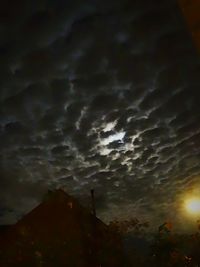 Low angle view of cloudy sky at night