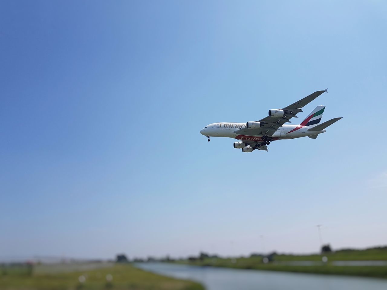 LOW ANGLE VIEW OF AIRPLANE AGAINST CLEAR SKY