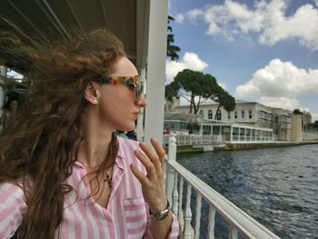 Woman looking at lake against sky