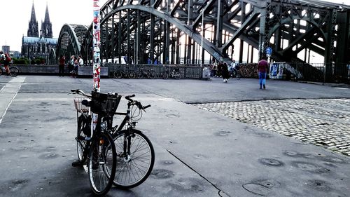 Bicycle parked on tree in city