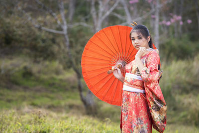 High angle view of woman holding umbrella