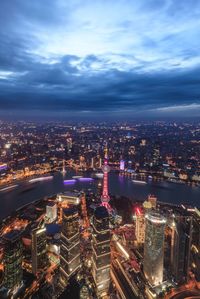 High angle view of oriental pearl tower and huangpu river in city at dusk