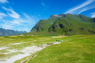 Scenic view of green landscape against sky