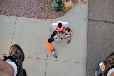 Low section of man over people standing on street