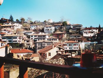 Buildings in city against clear sky