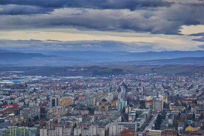 High angle view of city against cloudy sky