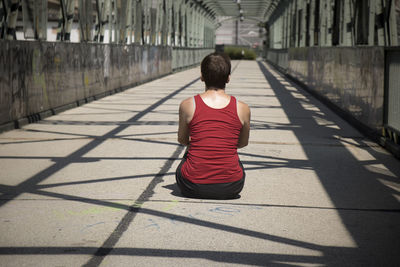 Rear view of woman walking on footpath