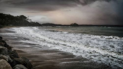 Scenic view of sea against cloudy sky