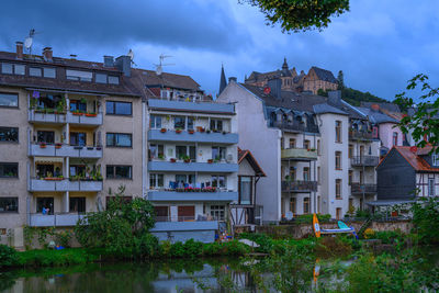 Residential buildings in town against sky