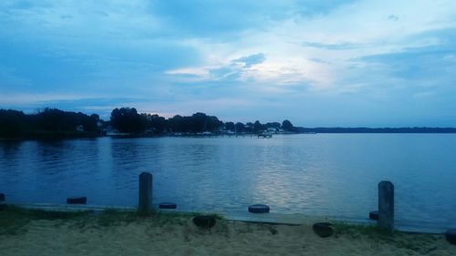 Calm lake with trees in background