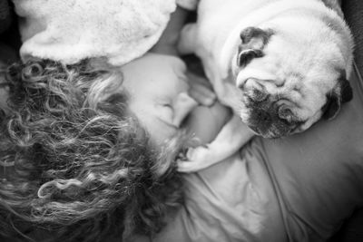 Woman sleeping with dog