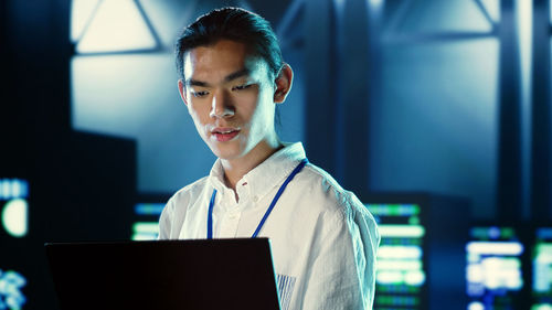 Businesswoman using laptop at office